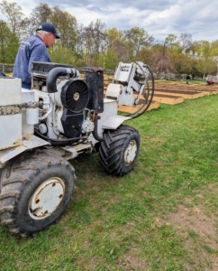 This machine was also brought in to help install a rubber hose under the ground for irrigation. I added three hose bibs in this space for watering.