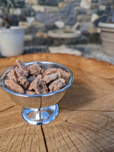 Small dishes of delicious candied pecans are placed on our outdoor tree tables.