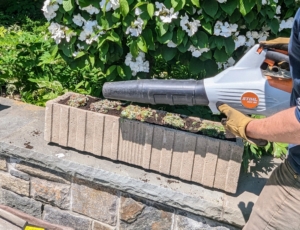 Next, Ryan uses this battery powered handheld blower from STIHL to clean the ledge of any dirt and soil. This blower is less noisy and perfect for around my Winter House.