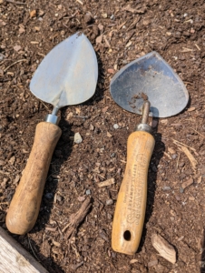 For planting vegetables, we use small shoveling tools. The mini trowel and mini shovel are from Gardener's Supply. They're perfect for making holes in the garden beds.