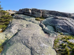 Cadillac Mountain features an ancient volcanic landscape. The granite mass was once a magma chamber more than two miles below the earth's crust. Time has gradually eroded the overlying rock, but the summit still exposes much of the hardened granite.