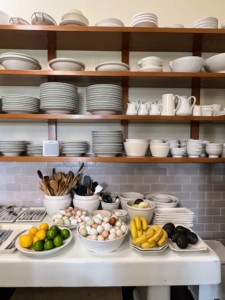 This is my ‘Great Wall of China’ – four open shelves that span nine-feet across one kitchen wall at Skylands. I love this wall - everything is visible and within easy reach. Below is a large table with utensils, small plates and bowls, and whatever fresh fruits, and eggs we have.