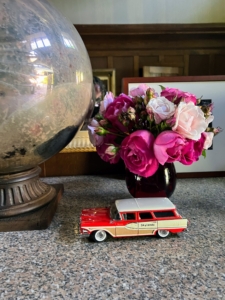 This is my long table in the entrance foyer of Skylands. I brought the roses up from my Bedford, New York farm, but the miniature classic 1958 Edsel Roundup two-door station wagon was gifted to me by my daughter, Alexis.