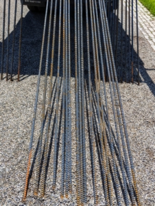 Rebar, short for “reinforcing bar” or “reinforcement bar”, is a metal bar often used with concrete settings. It is inexpensive and can be found at building supply shops.