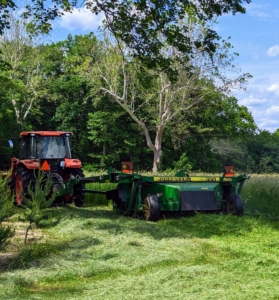 When weather conditions are ideal, these machines allow farmers to cut wide and fast – the best formula for quality field productivity. Chhiring goes over the field slowly and evenly with the mower-conditioner. As the mower-conditioner goes over the grass, it cuts it and then conditions it – all under the protective hood of the machine.