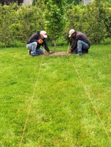 The first step is to mark exactly where the trees will be planted. The maze is drawn out on a map, so Fernando and Pete set up the landscape twine according to the map's specifications. This day was quite hazy because of the Canadian wildfires - one can see the difference in these images.