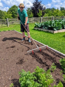 Ryan uses this bed preparation rake from Johnny’s Selected Seeds to create furrows in the soil. Hard plastic red tubes slide onto selected teeth of the rake to mark the rows. The furrows don’t have to be deep. In general, seeds should be planted at a depth of two times the width, or diameter, of the actual seed. A seed that’s about 1/16-of-an-inch thick should be planted an eighth-of-an-inch deep.