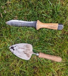For this planting project, Ryan has a trowel and a Hori Hori. Named after the onomatopoeia of a digging sound, the Hori Hori knife is a gardening knife with a sturdy, wooden handle and a beveled blade. The translation of Hori in Japanese is the word "dig."