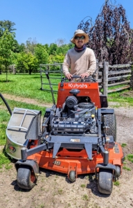 This is my outdoor grounds crew foreman, Chhiring, on our Kubota SZ22 Stand On Mower. He's heading into my new vegetable garden to mow in between the raised beds.