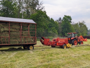 Then the same tractor is used to bale the hay a few days later. Here it is pulling the baler and the hay wagon.