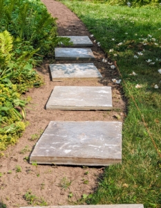 Here, I wanted the path made with large flagstone pavers placed several inches apart and surrounded with mulch. I have many stone materials already here at the farm and knew these would be perfect for this space.