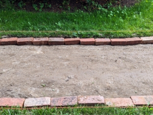Meanwhile, here is the last section of path lined with bricks and ready for stone dust.