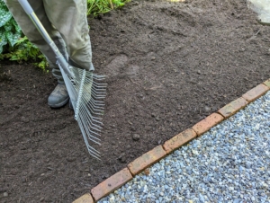 Next, Pete brings in lots of mulch to place around the paths as a finishing detail for the surrounding garden beds.