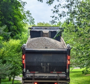 Large 10-wheel dump trucks can carry anywhere from 13 to 25 tons of gravel per load. Here is a truck filled with the 3/8-inch native stone gravel I selected. It would take many truck loads to cover the entire four miles of carriage road here at the farm.