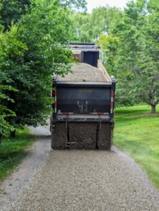 The gravel is dropped slowly and evenly.