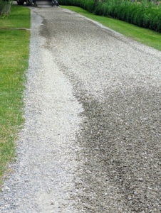 And here is what it looks like once it is dropped. The gravel is in the center of the road and now needs to be raked to fill the width of the 12-foot wide surfaces.