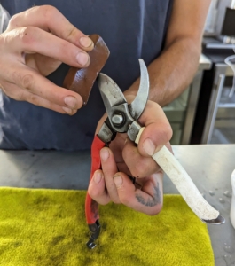 Brian holds the whetstone at an angle to sharpen the edges and maintain the bevel. The bevel is what makes a tool sharp, and blades are factory ground to a precise angle that’s just right for each tool.