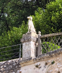 Here, a sculpture of a dog looks over the gardens from one of the terraces.
