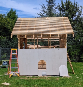 On one side, a door - turkey sized. In addition to the large barn door in the front, the turkeys will be able to walk in and out of the coop through this smaller doorway and down a ramp. The turkey coop is coming along. Wait until you see the end result. It looks great. Stay tuned.