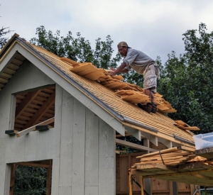 Here's Pete putting up the shingles on the south side if the roof. Each piece is hand-selected, so it fits perfectly.