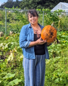 Elvira is pleased with some of the great pumpkins that grew this year - there are lots of good sized fruits.