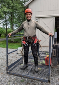 Here's Pasang all set in his safety gear and standing in the cage of our dependable Hi-Lo, ready to tackle the pin oaks.