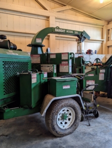 This is our wood chipper - an important piece of equipment at the farm. I am fortunate to have this machinery to chip fallen or cut branches and then return them to the woodland for top dressing various areas. It has a special parking spot in one corner of the space.