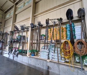 All the garden tools - hoes, spades, shovels, and rakes are hung on sturdy hooks.