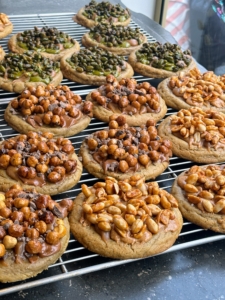 Here is a tray of Cédric's signature nut cookies - peanut butter cookies topped with a variety of nuts such as hazelnuts, also known as filberts, almonds, and pistachios. These cookies are about six-inches across - big enough to share, if one so desires.