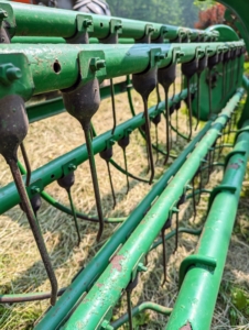 The bar rake, also known as a basket rake is hydraulically driven. This rake allows for consistent movement across the fields making well-shaped windrows.