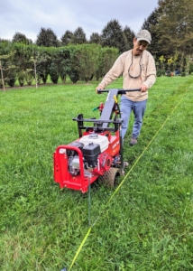 The next step is to remove the sod from the designated area. This is done with our Classen Pro HSC18 sod cutter. This sod cutter is so easy to maneuver and so sharp, Chhiring finishes one row in just minutes.