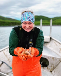 And here she is with side stripe Alaska shrimp. These shrimp are slender, pinkish-orange in color, with white stripes running lengthwise on the body. They can reach about eight-inches in length. They have a firm texture and a naturally sweet, succulent flavor. (Photo courtesy of Hannah Heimbuch)