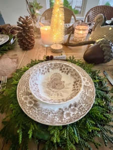This beautiful table is at the home of Tess and Laurent Ceron. It includes lovely fall woodland themed decorations and classic turkey plates.