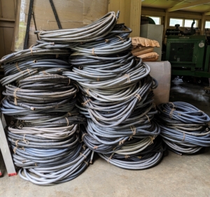 All the hoses around the farm are gathered, drained, recoiled, tied, and then stored away for the season.