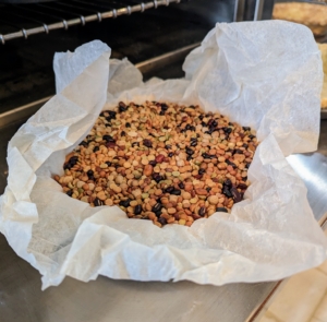 Here is one pie crust baked and ready to empty of its bean weights. I've been using the same dried beans for more than 25-years. I reuse them time after time and store them in a big glass jar in my kitchen.