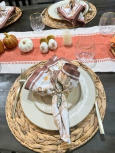 Cindy writes, "I use my wedding Lenox China, Williams-Sonoma napkins and pumpkin glasses, flatware from Target, and a table runner from Amazon."
