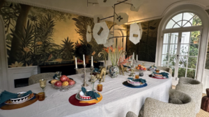 Here is a picture from Jason Duzansky's Thanksgiving table. "The plates are by Palio di Siena, napkin holders by the Haas Brothers. The monkeys are vintage as well as the vase, glasses, candle holders. The dining room is in the gallery of The Future Perfect that my husband David Alhadeff owns. It’s also our home."