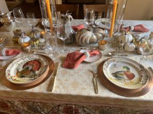 Here's a Thanksgiving table in Las Cruces, New Mexico, just north of El Paso, Texas. Marc Legarreta "had purchased a fresh garland for the table but it didn’t arrive on time! So I had to improvise with some dollar store pumpkins!"