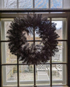 Here's another wreath hung on a window looking out onto my courtyard. Wreaths originated as holiday decorations in connection with Yule, which marked the winter solstice, which was celebrated by the ancient Germanic and Scandinavian peoples. The wreaths were a symbol of spring and a promise of its return.