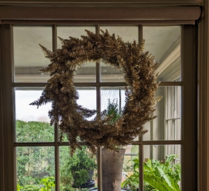 This wreath is on an interior window of my sitting room with my enclosed porch on the other side.