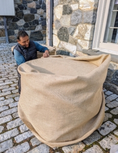 Pete wraps this entire vessel from top to bottom with the burlap, tucking it all in underneath.