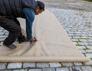 Pete cuts the burlap fabric to fit – one long piece that can completely wrap around the urn.