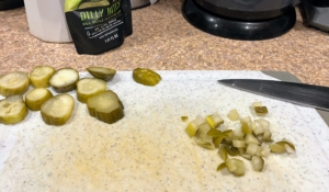 Meanwhile, while some of the pickle slices are reserved for the burgers, some are chopped for the sauce and saved with two tablespoons of pickle juice.