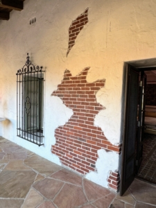 This is called weeping mortar, a style that involves applying a very large amount of mortar when laying brick, but then not scraping or molding the mortar after it seeps out between the bricks.