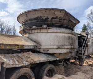 Tub grinders are named for the distinctive in-feed hopper – the large round tub, normally 10 to 14-feet in diameter and roughly six-feet deep. It is moved into position close to the wood pile. Before any equipment is used, all the controls are checked to make sure everything is in good working order.