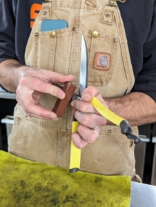 Brian holds the whetstone at an angle to sharpen the edges and maintain the bevel. The bevel is what makes a tool sharp. The blades are factory ground to a precise angle that’s just right for each tool.