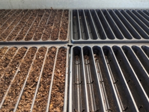 Seed starting trays come in all different sizes and depths. We use trays with shallow compartments for planting onion seeds. These are 20-row seed flats from Johnny’s Selected Seeds. They keep varieties separate and make the removal of seedlings easy for transplanting to larger celled trays or pots later.