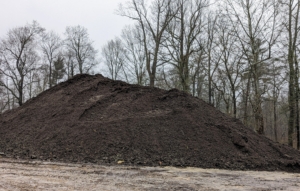 After the second grind, the mound looks like this - beautiful, dark usable mulch which we use during the rest of the year to top dress the garden beds.