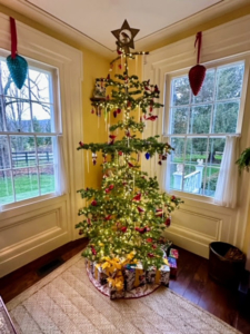 It is often referred to as a "Charlie Brown" Christmas tree. The spaces between the limbs highlight the ornaments and are reminiscent of Christmas trees from the 1920s and 1930s.