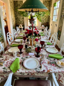 Here is the holiday table - set with antique Wedgwood plates edged in red and gold. The festive tablecloth is a discontinued print from Cowtan & Tout. Anthony arranged the flowers in the center cachepot and Christopher made the golf lustre faux barrel cachepots in his New York Studio.